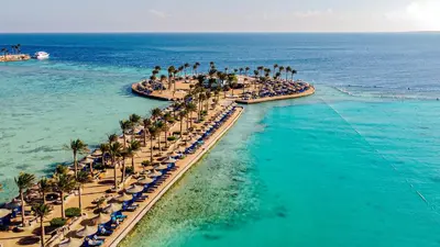 an aerial view of a beach with palm trees and the ocean at Arabia Azur Resort in Hurghada