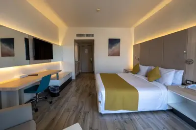 a hotel room with a bed and a desk at JAZ Palmariva Beach in Hurghada