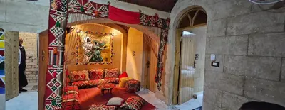 a living room with a couch and a painting on the wall at Queen House in Aswan