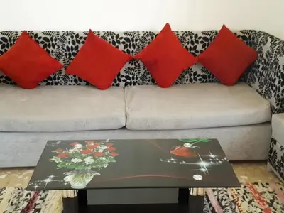 a couch with red pillows and a coffee table at Villa Dream in Luxor