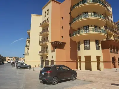 a car parked in front of a building at EL Gouna Abu tig marina studio- economy stay in Hurghada