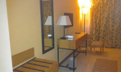 a room with a mirror and a table and a lamp at EL Gouna Abu tig marina studio- economy stay in Hurghada