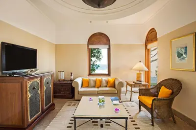 a living room with a couch and a tv at The Oberoi Beach Resort, Sahl Hasheesh in Hurghada