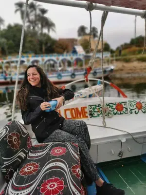 a woman sitting on a boat at Luxor Plaza House in Luxor