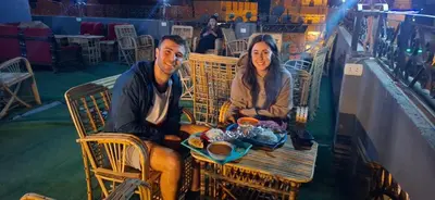 a man and a woman sitting at a table at david hostel in Aswan