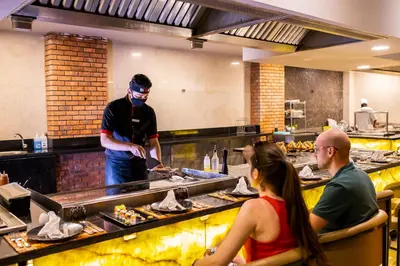 a man preparing food in a restaurant kitchen at Bellagio Beach Resort & Spa in Hurghada