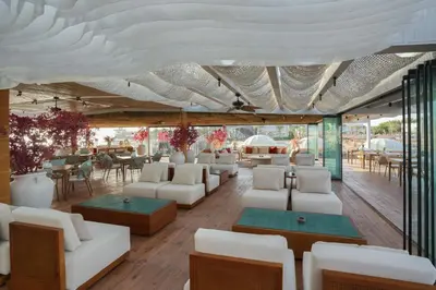 a large room with white furniture and tables and chairs at Desert Rose in Hurghada