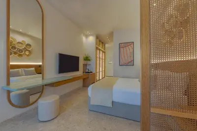 a bedroom with a bed and a mirror and a television at Desert Rose in Hurghada