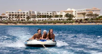 a group of people riding on a raft in the water at Old Palace Resort Sahl Hasheesh in Hurghada