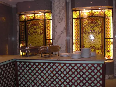 a restaurant with plates on a counter with stained glass windows at Philippe Luxor Hotel in Luxor