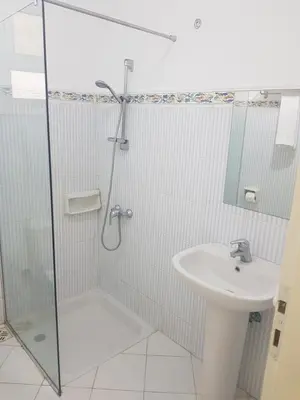 a bathroom with a shower and a sink at Lilly Rooms and Studio in Hurghada