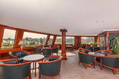 a restaurant with tables and chairs and large windows at Sonesta St George Nile Cruise - Aswan to Luxor 3 Nights from Friday to Monday in Aswan