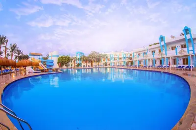 a large swimming pool at a resort with blue skies at Mirage Bay Resort & Aqua Park in Hurghada