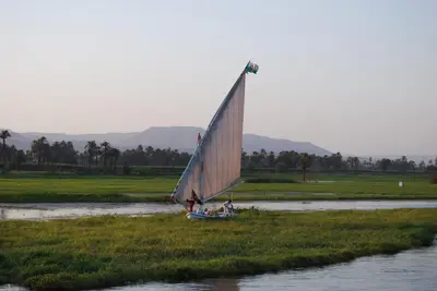 a group of people on a sail boat on a river at Rezeiky Hotel & Camp 您在盧克索的第二個家 in Luxor