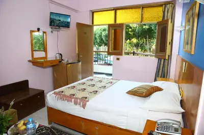 a bedroom with a bed and a window at Rezeiky Hotel & Camp 您在盧克索的第二個家 in Luxor