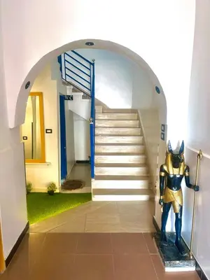 a statue of a superhero standing in front of a staircase at Villa Sunrise in Luxor