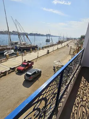 a view of a marina with cars and boats at Villa Sunrise in Luxor