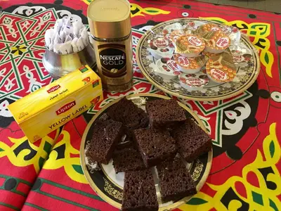 a table topped with two plates of brownies and desserts at New Memnon Hotel in Luxor