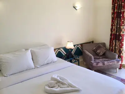 a bedroom with a bed with a towel on it at New Memnon Hotel in Luxor