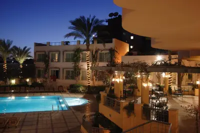 a view of a hotel with a swimming pool at night at Sea Garden Hotel in Hurghada