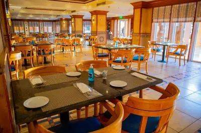 a dining room with tables and chairs in a restaurant at Continental Hotel Hurghada in Hurghada