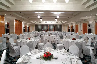 a large banquet hall with white tables and chairs at Continental Hotel Hurghada in Hurghada