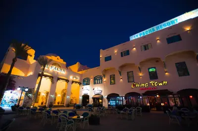 a group of buildings with tables and chairs at night at Le Pacha Resort in Hurghada