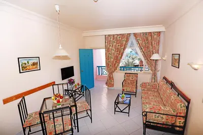 a living room with a couch and a table and chairs at Le Pacha Resort in Hurghada