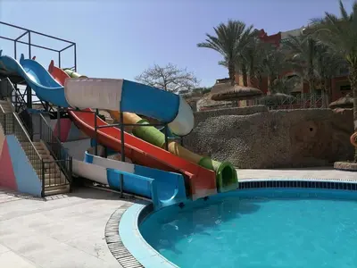 a water slide in a pool at a resort at Sun & Sea Hotel and Aqua Park - Hurghada in Hurghada