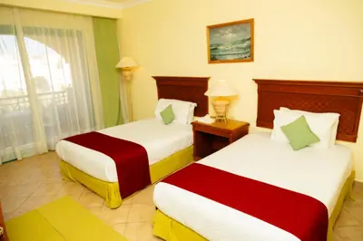 a hotel room with two beds and a window at Sun & Sea Hotel and Aqua Park - Hurghada in Hurghada
