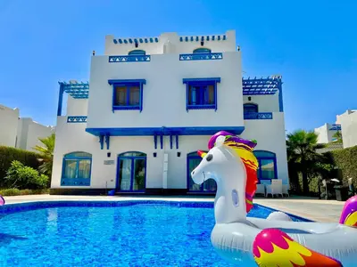 a house with a pool with a unicorn in front of it at Luxury Villa with pool in Hurghada in Hurghada