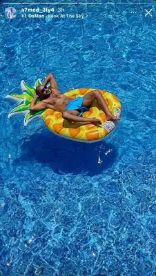 a woman laying on anlatable raft in the water at Luxury Villa with pool in Hurghada in Hurghada