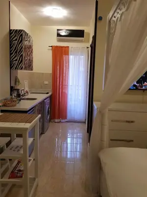 a kitchen with a red curtain in a room at Tiba Resort Hurghada in Hurghada