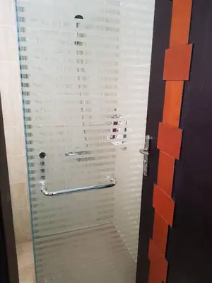 a bathroom with a shower with a glass door at Tiba Resort Hurghada in Hurghada