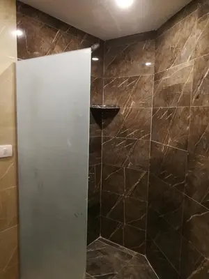a shower with a glass door in a bathroom at Cordoba Suites in Hurghada