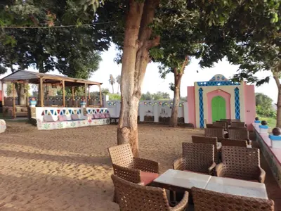 a playground with a table and chairs and a play house at Maghrabi's Guest house in Aswan