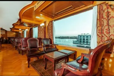a train car with chairs and a table and a window at Nile Cruise King Tut in Luxor