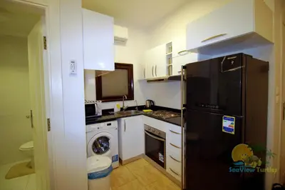 a kitchen with a black refrigerator and a dishwasher at SeaView Turtles in Hurghada