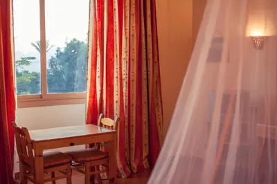 a table and chair in a room with a window at Ali Baba Safaga Hotel in Hurghada
