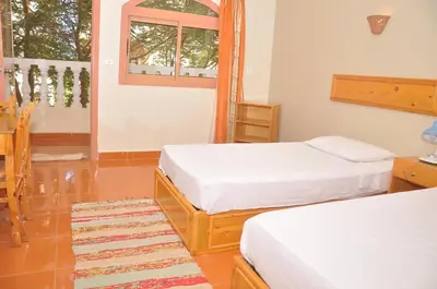 a room with two beds and a window at Ali Baba Safaga Hotel in Hurghada