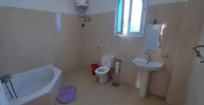 a bathroom with a sink and a toilet and a tub at Enjoy Luxor in Luxor
