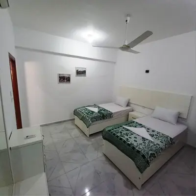 a room with two beds and a ceiling at Enjoy Luxor in Luxor