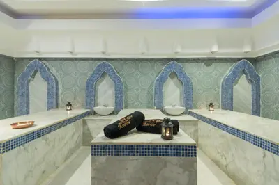 a bathroom with two sinks and two mirrors at Shams Lodge in Hurghada