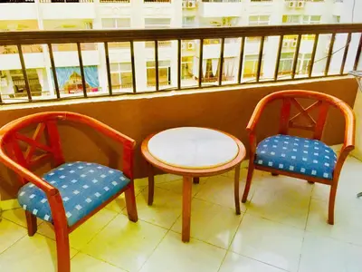 two chairs and a table on a balcony at Solider Art in Hurghada