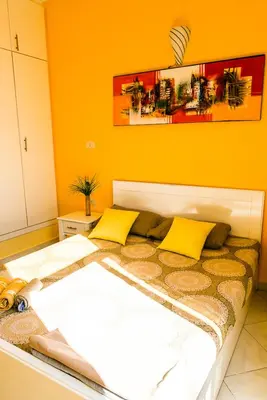 a bed with two yellow pillows in a room at Solider Art in Hurghada