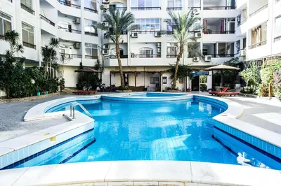 a large swimming pool in front of a building at Solider Art in Hurghada