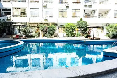 a large swimming pool in front of a building at Solider Art in Hurghada