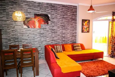 a living room with a couch and a brick wall at Desert Pearl Art in Hurghada