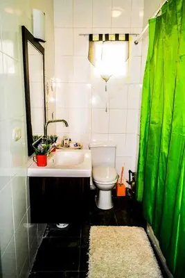 a bathroom with a toilet and a sink and a mirror at Desert Pearl Art in Hurghada