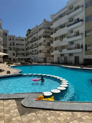 a person in a swimming pool with a pool toy at Lotus compound in Hurghada